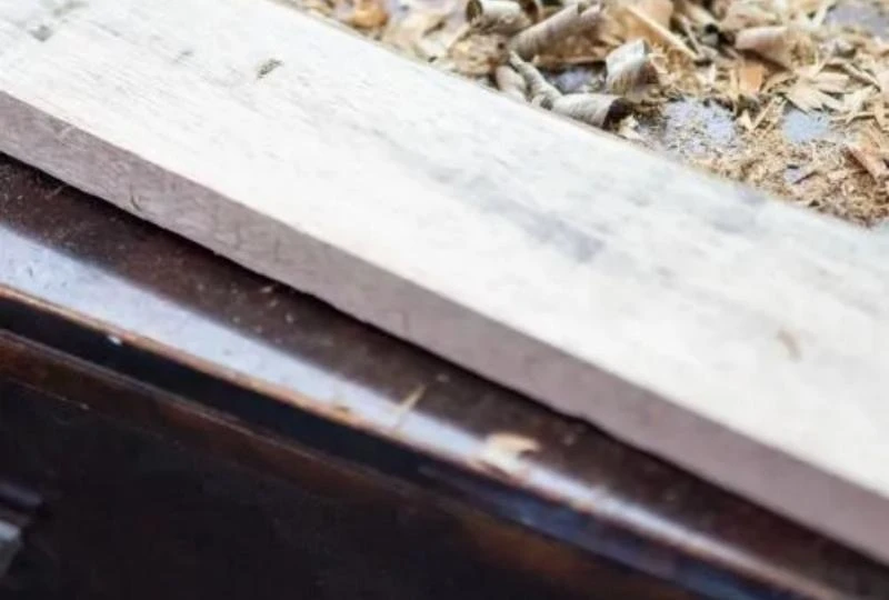 Wood dust accumulation during the polishing process.
